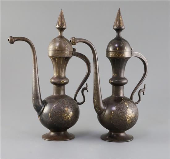 A pair of 19th century Qajar gold inlaid iron rosewater sprinklers, H.12.5in.